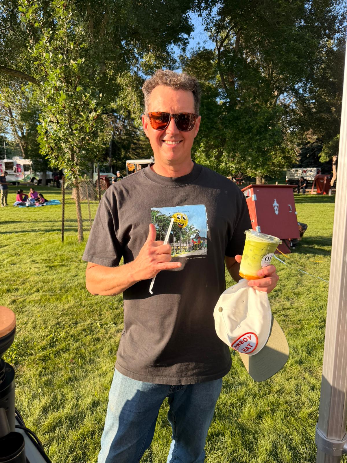 A guest outdoors on a sunny day enjoying a fresh OTB nitro matcha