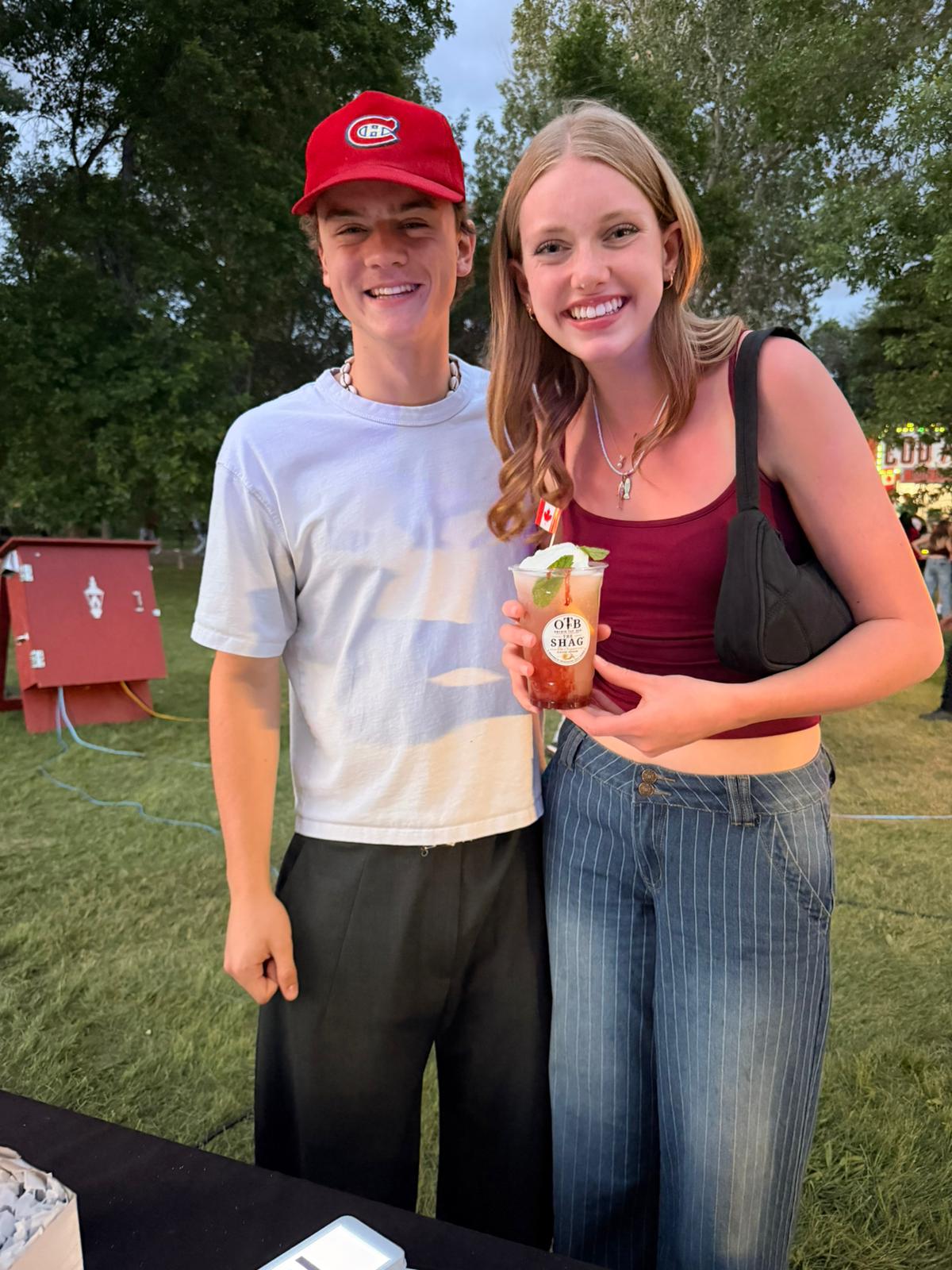 A young couple smiling with an OTB Shag float in hand