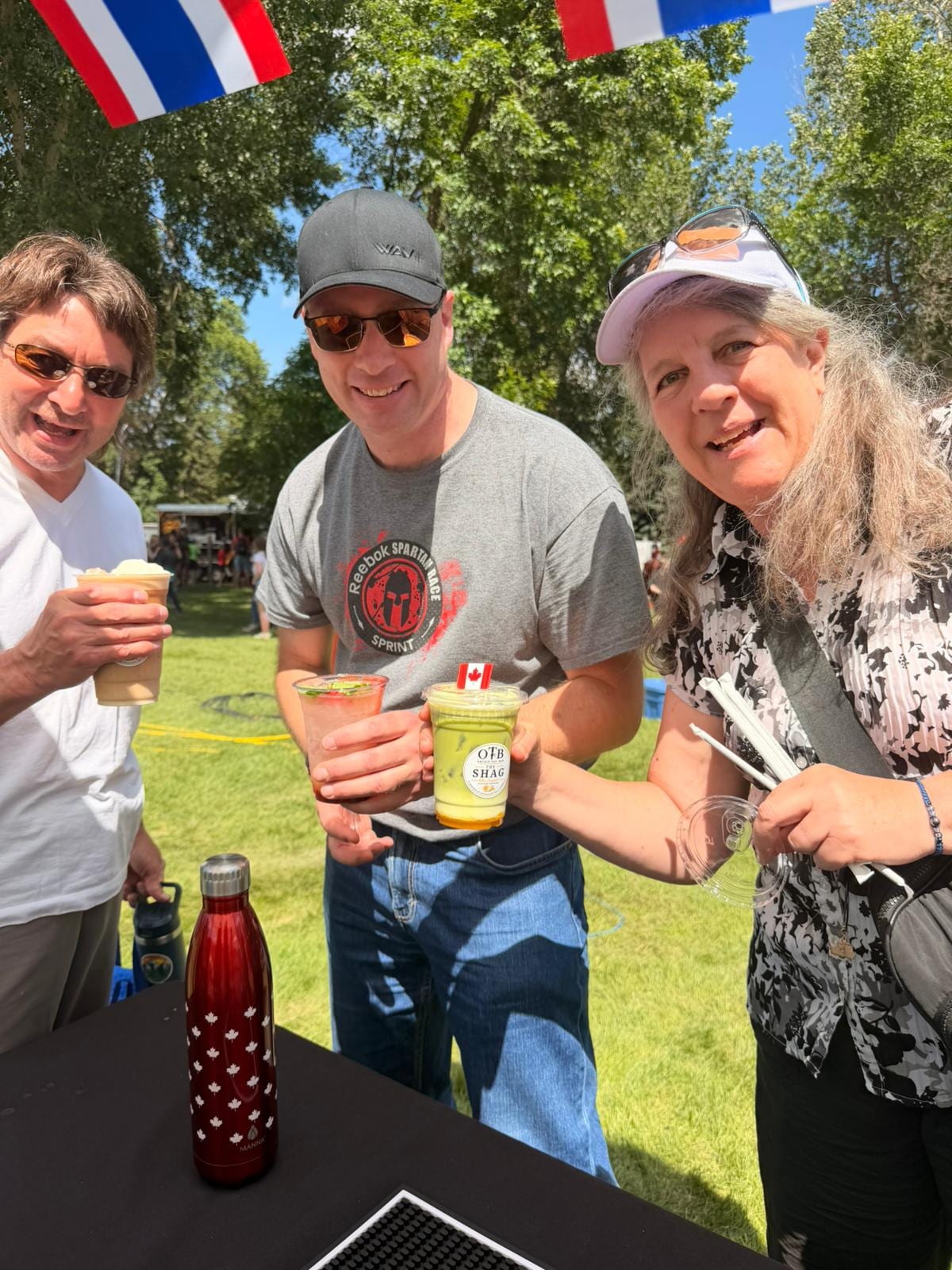 A group of guests raising their OTB drinks together at the festival