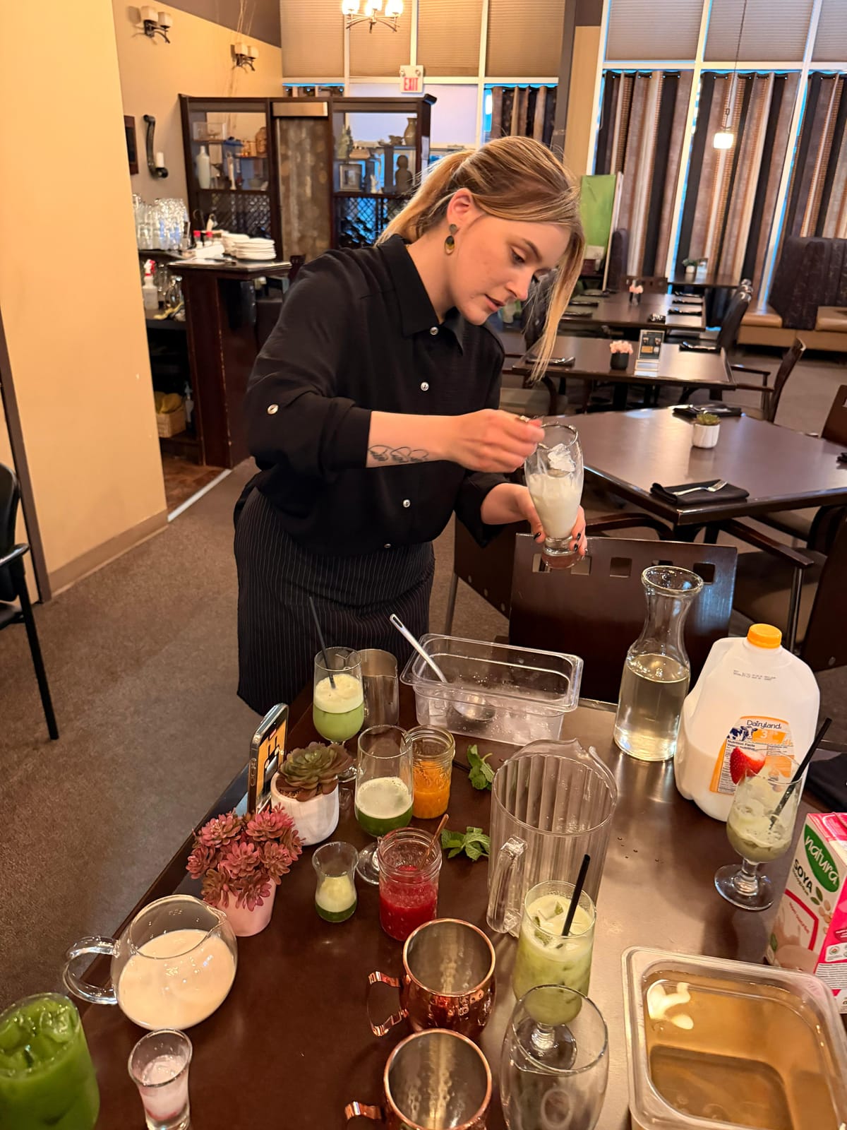 A barista crafting a spread of colourful handcrafted beverages