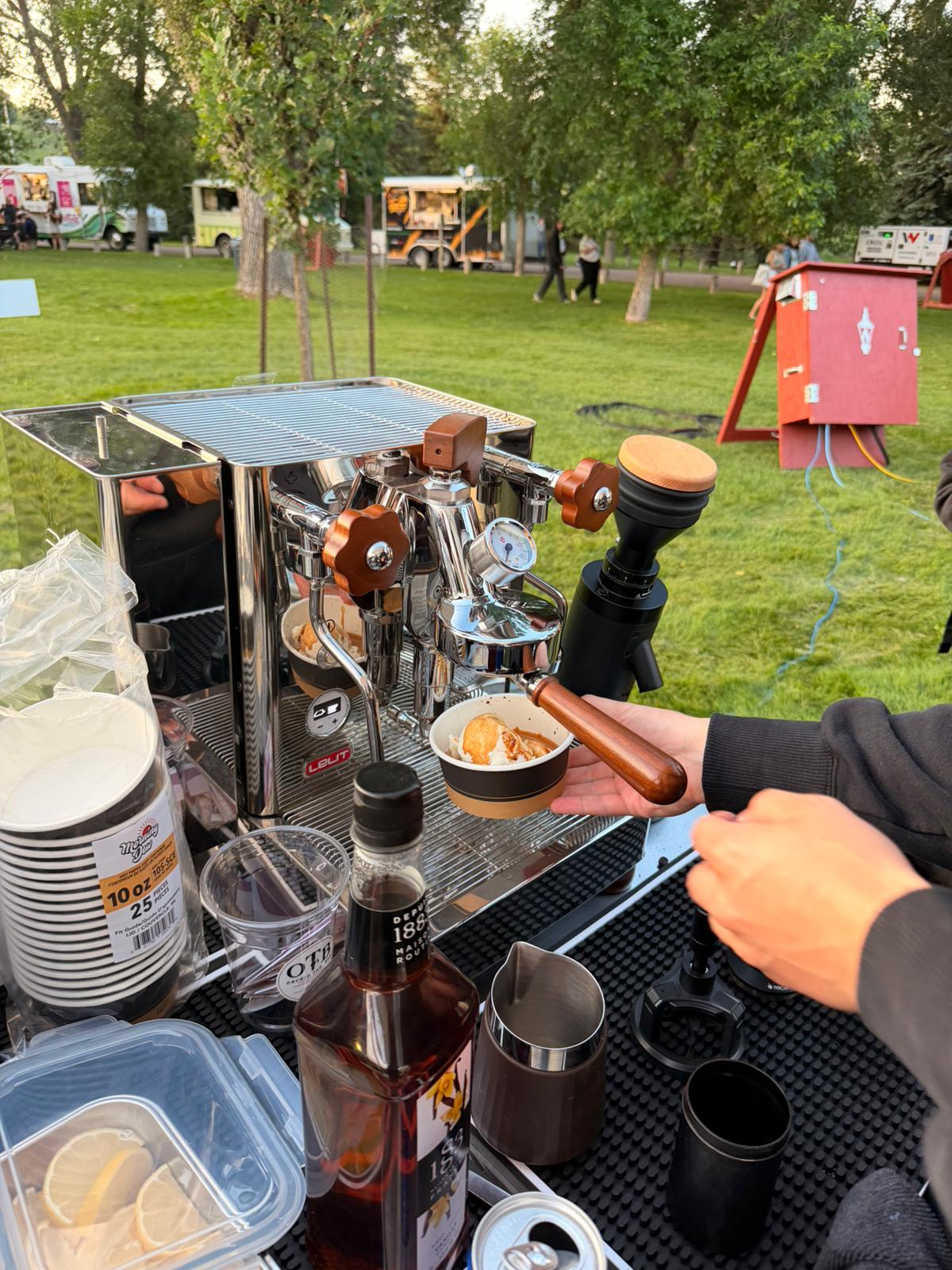 A smiling guest holding an OTB Shag lemonade at a summer festival